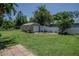 A backyard with a shed, fence, and grass at 11418 Lake Eustis Dr, Leesburg, FL 34788