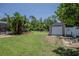 A backyard with a shed, fence, pool, and landscaping at 11418 Lake Eustis Dr, Leesburg, FL 34788