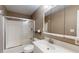 Cozy bathroom with a shower over the bathtub, a white vanity, and a mirror at 11418 Lake Eustis Dr, Leesburg, FL 34788
