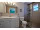 Bright bathroom featuring a shower with glass door, and a stylish vanity with mirror at 11418 Lake Eustis Dr, Leesburg, FL 34788