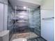 Modern bathroom featuring a walk-in shower with blue-tiled walls and a glass door at 11418 Lake Eustis Dr, Leesburg, FL 34788
