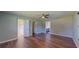 Large bedroom with wood floors, three doorways, and neutral walls at 11418 Lake Eustis Dr, Leesburg, FL 34788