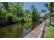 Lakeside dock featuring a boat lift and space for relaxing by the water at 11418 Lake Eustis Dr, Leesburg, FL 34788