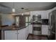 This modern kitchen features stainless appliances, granite counters, and sleek cabinetry for a seamless cooking experience at 11418 Lake Eustis Dr, Leesburg, FL 34788