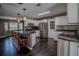 Open-concept kitchen boasts granite countertops, stainless steel appliances, and a breakfast bar with seating for three at 11418 Lake Eustis Dr, Leesburg, FL 34788