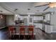 This modern kitchen features stainless appliances, granite counters, and sleek cabinetry and breakfast bar for entertaining at 11418 Lake Eustis Dr, Leesburg, FL 34788