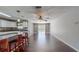 Open living space connecting the kitchen and living room with hardwood floors at 11418 Lake Eustis Dr, Leesburg, FL 34788
