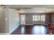 Open-concept living room with hardwood floors, bay windows, and modern lighting at 11418 Lake Eustis Dr, Leesburg, FL 34788