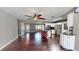 Bright living room and kitchen area with dark wood floors and a ceiling fan for a modern, inviting feel at 11418 Lake Eustis Dr, Leesburg, FL 34788