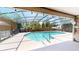 A screened-in pool with landscaping at 11418 Lake Eustis Dr, Leesburg, FL 34788