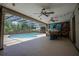 Relaxing screened-in pool area with ample lounge space and a boat-themed bar at 11418 Lake Eustis Dr, Leesburg, FL 34788