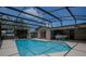 Inviting screened-in pool area with lush surroundings, perfect for outdoor enjoyment at 11418 Lake Eustis Dr, Leesburg, FL 34788