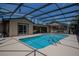 A screened-in pool with ladder and view of the exterior of the house at 11418 Lake Eustis Dr, Leesburg, FL 34788
