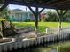 Backyard with dock, hammock, white picket fence and lush green lawn at 11812 Watts Ct, Tavares, FL 32778