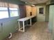 Unfinished basement featuring a pegboard wall, workbench, and vintage-style flooring at 11812 Watts Ct, Tavares, FL 32778