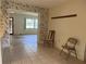 Open dining area with tile flooring, transitioning to a living space at 11812 Watts Ct, Tavares, FL 32778