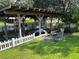 Covered boat dock on the canal with a white picket fence at 11812 Watts Ct, Tavares, FL 32778