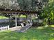 Dock featuring covered boat slip, wooden beams, and easy access to water at 11812 Watts Ct, Tavares, FL 32778
