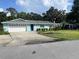 Charming single-story home with a well-maintained lawn and large driveway at 11812 Watts Ct, Tavares, FL 32778