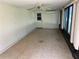 Enclosed Florida room with tile flooring, large windows, and a ceiling fan with outdoor access at 11812 Watts Ct, Tavares, FL 32778