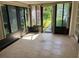 Bright sunroom with tile floors, large windows, and access to the outdoors, perfect for relaxation at 11812 Watts Ct, Tavares, FL 32778