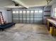 Garage interior with a large roll-up door and workbench area at 11812 Watts Ct, Tavares, FL 32778