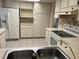 Bright kitchen featuring white appliances, tile floors, and ample storage space at 11812 Watts Ct, Tavares, FL 32778