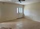 Bright living room with tile flooring and a ceiling fan, featuring a door with decorative glass at 11812 Watts Ct, Tavares, FL 32778