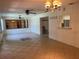 Open-concept living space with tile flooring, a ceiling fan, and a view into adjacent rooms at 11812 Watts Ct, Tavares, FL 32778