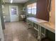 Utility room featuring utility sink, pegboard, and shelving at 11812 Watts Ct, Tavares, FL 32778