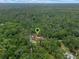 Aerial view of home nestled in lush greenery with pinpoint location marker at 12288 Sw 35Th Dr, Webster, FL 33597
