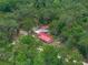 Aerial view of home surrounded by trees featuring a detached garage at 12288 Sw 35Th Dr, Webster, FL 33597
