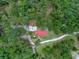Birds-eye view showcases a home with a red roof nestled amongst trees, accessible by a long winding driveway at 12288 Sw 35Th Dr, Webster, FL 33597