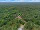 Aerial view of a wooded area with home and a pinpoint location marker at 12288 Sw 35Th Dr, Webster, FL 33597