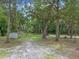 Lush backyard featuring mature trees, providing privacy and a serene outdoor space at 12288 Sw 35Th Dr, Webster, FL 33597