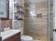 Modern bathroom with tiled walk-in shower, sleek vanity, and convenient storage shelves at 12288 Sw 35Th Dr, Webster, FL 33597