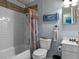 Bathroom featuring a shower-tub combination with rustic decor and seaside accents at 12288 Sw 35Th Dr, Webster, FL 33597