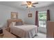 Bright bedroom with a comfortable queen-sized bed and ample natural light at 12288 Sw 35Th Dr, Webster, FL 33597