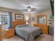 Cozy bedroom featuring wood furniture and comfortable furnishings with a view to the outside at 12288 Sw 35Th Dr, Webster, FL 33597