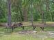 Picturesque fire pit area with bench seating, perfect for cozy evenings and gatherings at 12288 Sw 35Th Dr, Webster, FL 33597