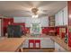 View of the kitchen, showcasing ample counter space and bright, red-themed decor at 12288 Sw 35Th Dr, Webster, FL 33597