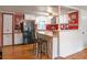 Charming kitchen with white cabinetry, black appliances, and cozy breakfast bar seating at 12288 Sw 35Th Dr, Webster, FL 33597