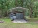 Storage shed in backyard with a convenient carport for vehicles or equipment at 12288 Sw 35Th Dr, Webster, FL 33597
