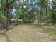 View of lush green yard with established trees and outbuildings at 12288 Sw 35Th Dr, Webster, FL 33597