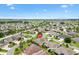 An aerial view of a home in a Primary-planned community highlighting mature landscaping, and quiet neighborhood at 1376 Birdsong Pl, The Villages, FL 32163
