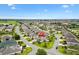 An aerial view of the property highlighting its location in a Primary-planned community with mature landscaping at 1376 Birdsong Pl, The Villages, FL 32163