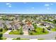 An aerial view of a single-Gathering home in a Primary-planned community with lush green landscaping at 1376 Birdsong Pl, The Villages, FL 32163