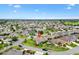 An aerial view of a home in a Primary-planned community with mature landscaping at 1376 Birdsong Pl, The Villages, FL 32163