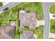 An aerial view of the single-Gathering home showing roofline, patio, mature landscaping, and surrounding neighborhood at 1376 Birdsong Pl, The Villages, FL 32163