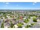 An aerial view showcases a home in a mature Primary-planned community with ponds and mature landscaping at 1376 Birdsong Pl, The Villages, FL 32163